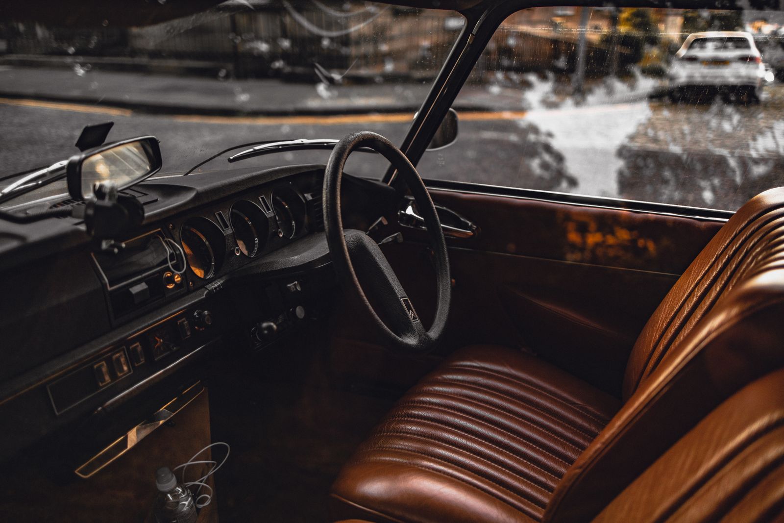 The worn leather, dusty glass and left-behind clutter of a much-used older car